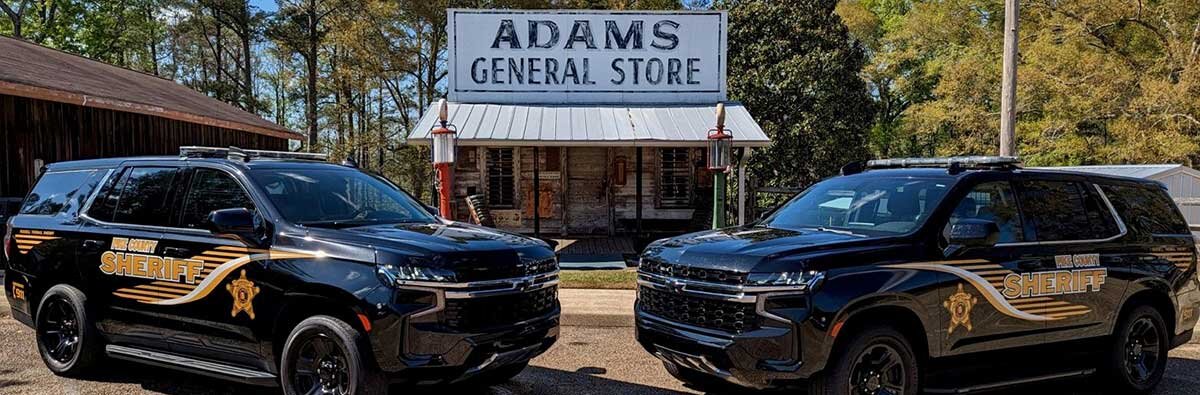 Sheriff's Office Patrol Vehicles in front of Adams General Store